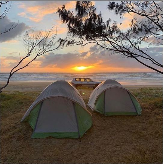 Camping site with tents looking over the K'gari beach (Fraser Island) at sunrise